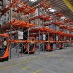 Business manager analyzing warehouse inventory and working capital using inventory management software and financial reports.