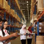 Warehouse manager performing ABC Analysis to classify inventory into high, medium, and low-value categories using inventory management software.